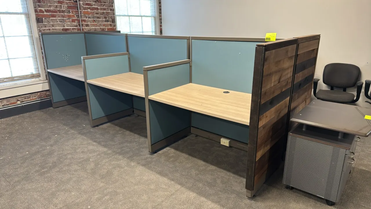 6-station cubicle workspace. Features fabric-covered partition panels, laminate desktop work surfaces with wire grommet pass-throughs, metal trim, rus
