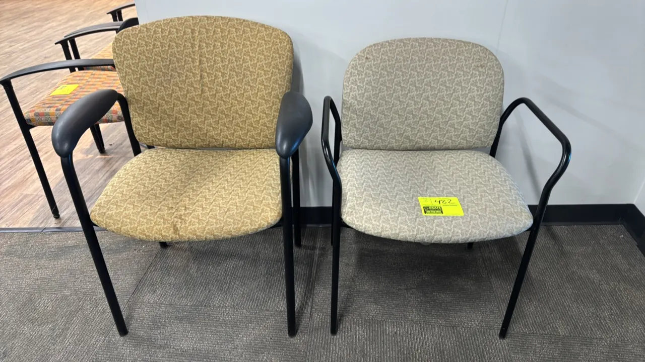 Upholstered metal side armchairs. Features padded fabric seats and backrests in assorted patterns and colors and integrated armrests. Mounted on black