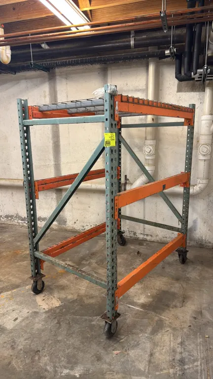 Interlake portable racking cart. Features teardrop uprights, orange step beams, and wire mesh decking. 60"W x 36"D x 65"H. Mounted on casters.