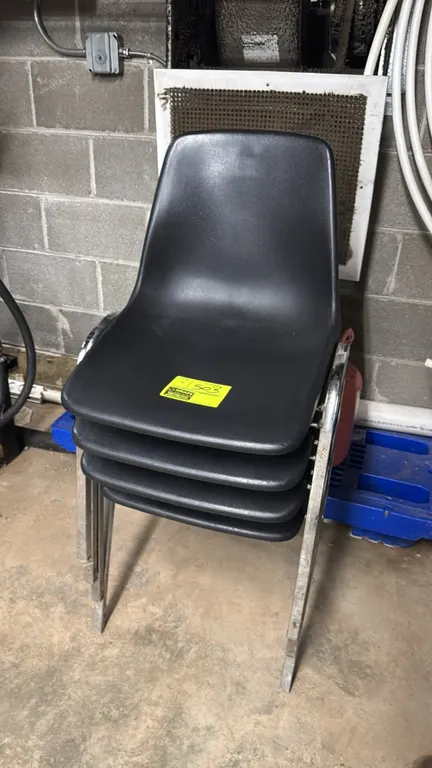 Poly stacking chair. Features a black molded plastic seat shell and chrome metal frame. Stackable design.
