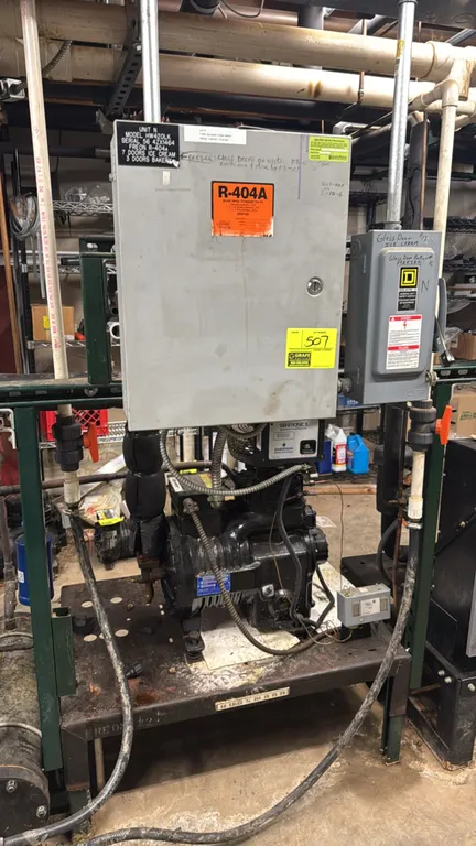 Hussmann HW420LK low-temp refrigeration compressor rack. Features a 2011 Copeland 5 HP compressor (model MRA2-050A-TFC-800, S/N: 11F67570R), control b