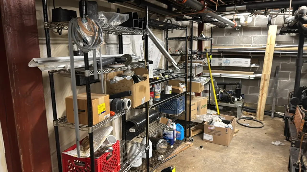Package lot of metal multi-tier wire shelving racks with assorted contents and wall-mounted storage. Includes (1) 3'L and (2) 4'L racks with adjustabl