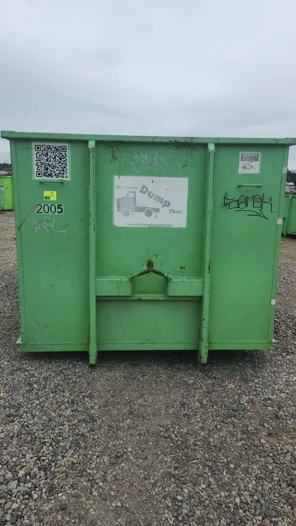 20-yard roll-off dumpster container. Features rear double barn doors, bottom rollers, side board pockets with wood boards, and hooklift attachment wit