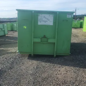 20-yard hooklift dumpster container. Features rear double barn doors with locking latch mechanism, side wood plank pockets, and bottom ground roller. 