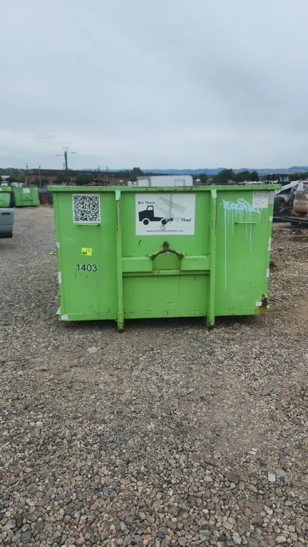15-yard hooklift roll-off dumpster container. Container #1403. Features 36" hook height, rear double barn doors with dual latches, and bottom roller.
