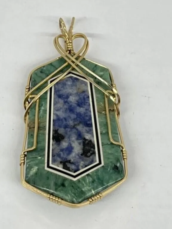 Modern Pendant with a Gold tone Wire Frame that