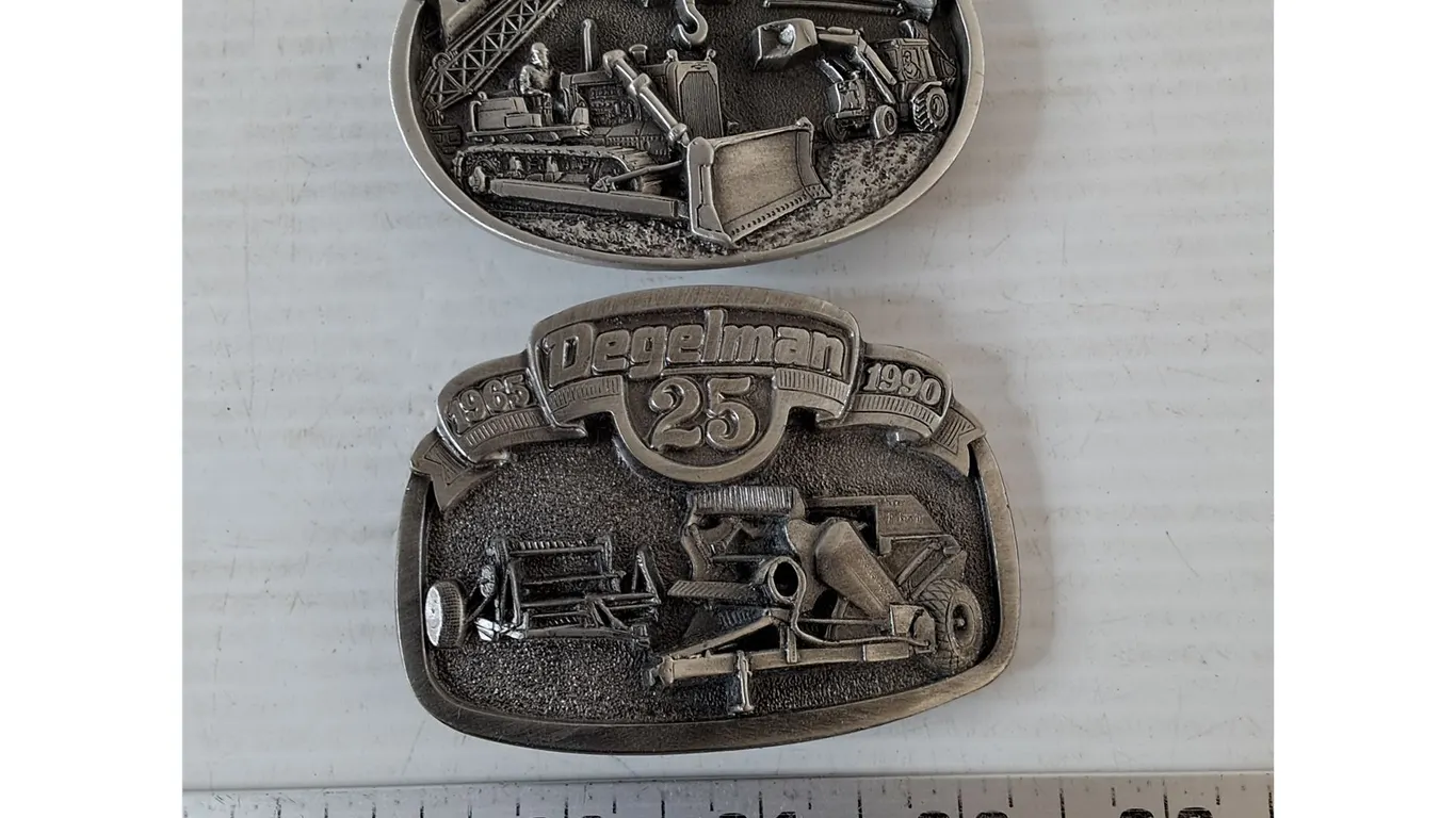 (2) Belt Buckles, Degelmen 25th and Heavy Equipment Operator