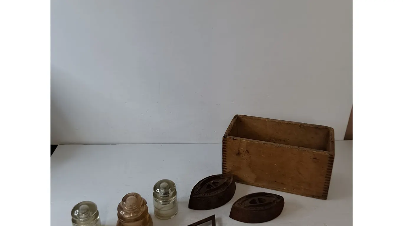 (3) Vintage Glass Electrical Insulators, (2) Metal Irons, (1) Iron Stand, (1) Wooden Box