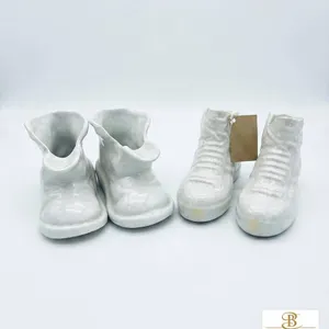 Two Pairs of White Glazed Ceramic Baby Shoe Figurines