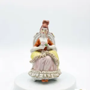 Porcelain Figurine of Seated Lady in Detailed Dress