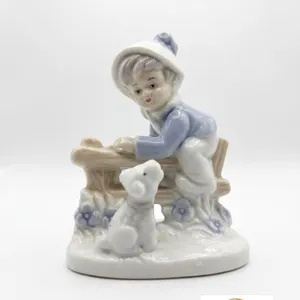 Porcelain Figurine of Boy in Blue Coat with Dog by Fence