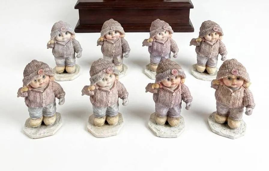 8 Porcelain Girl Figurines in Winter Clothing