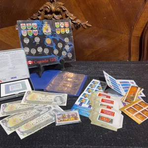 Canada 125 Coin Set, Canadian One Dollar Bills, Assorted Mint Stamps and Wild West Card