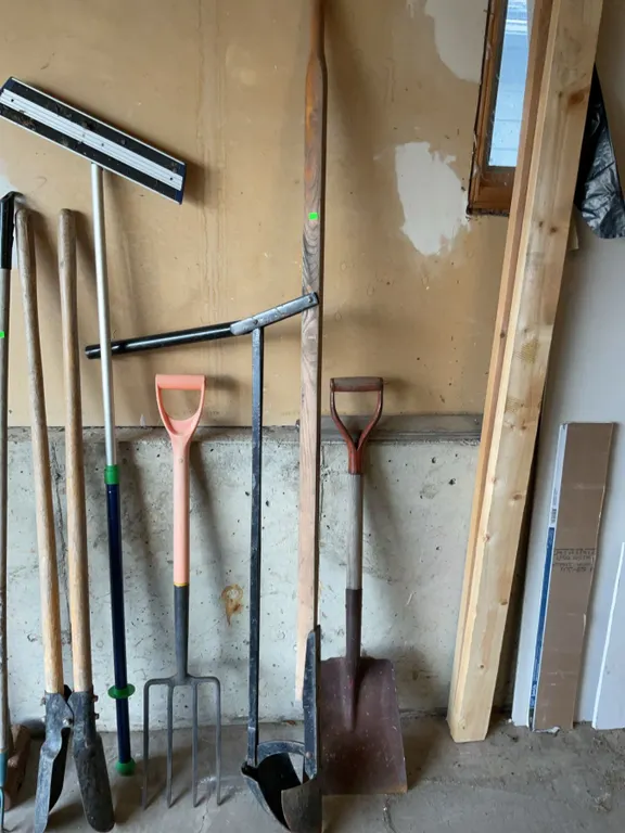 Gardening and Winter Tools with Snow Shovel and Two Post Hole Diggers