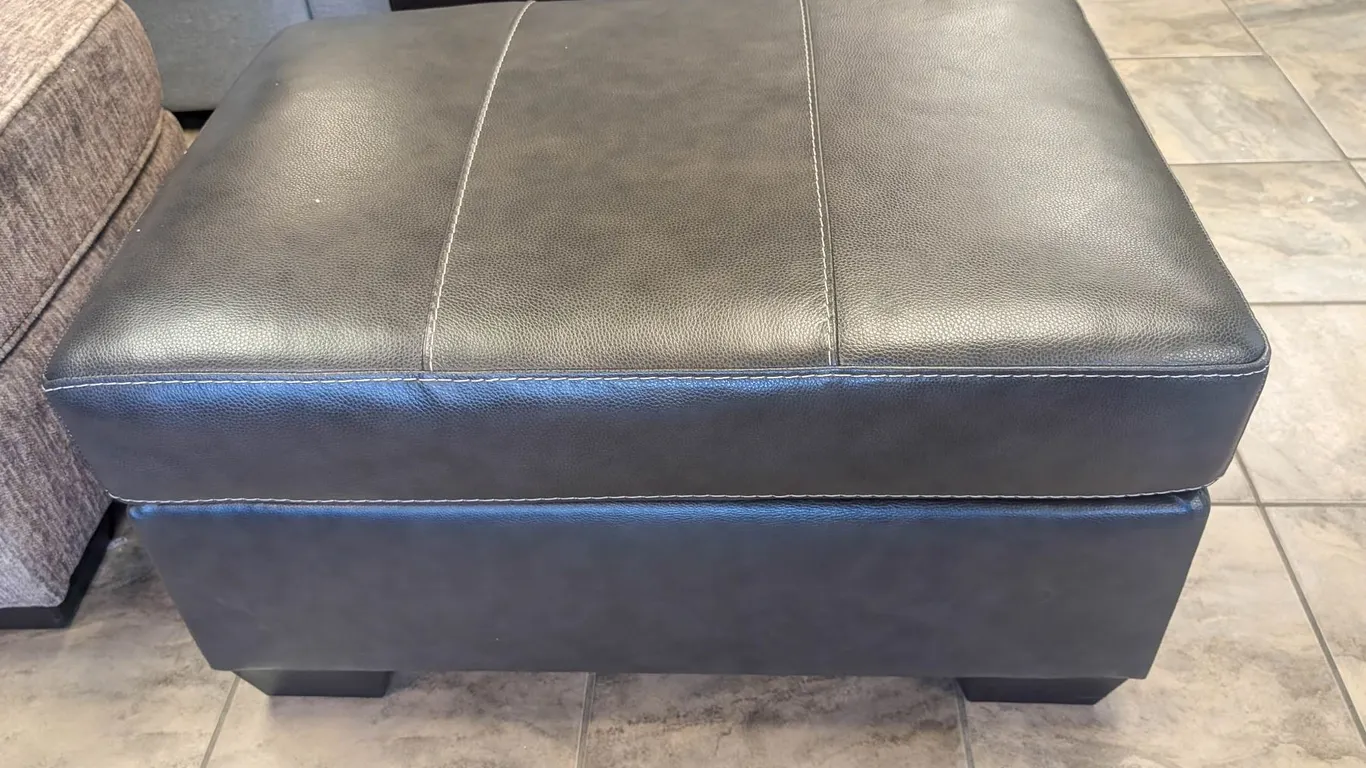 ONSITE: ASHLEY MORELOS GREY LEATHER OTTOMAN