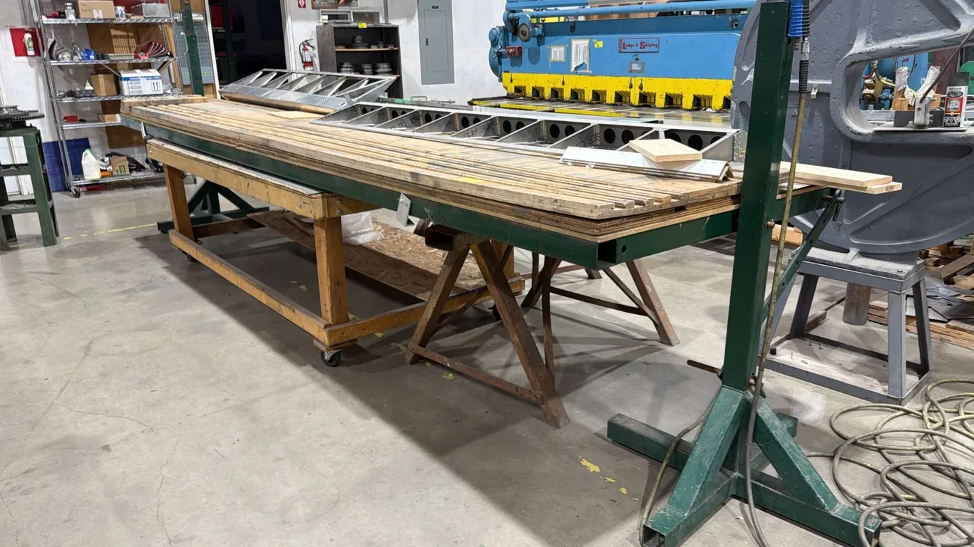 16FT STEEL WORK BENCH WITH CHANNELED WOOD TOP, METAL STANDS, 8FT PORTABLE WOOD TABLE & ASSORTED
