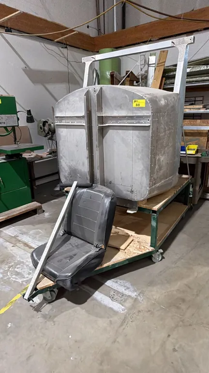 ALUMINUM AIRPLANE COCKPIT WITH SEATS ON 4-WHEEL 2-TIER STEEL PULL CART APPROX 7.5FT X 44IN X 80IN