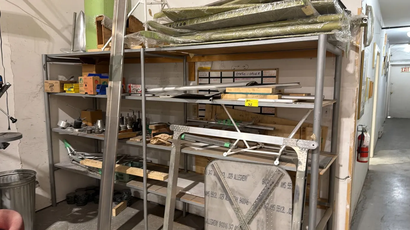 4-TIER SHELVING UNIT WITH ASSORTED CONTENTS INCLUDING; ALUMINUM PARTS, WOOD BLOCKS, OIL CAN,