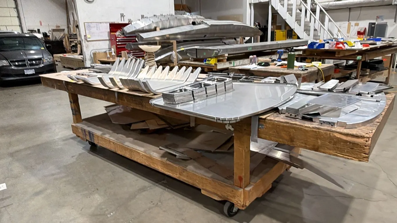 LARGE 2-TIER PORTABLE WOOD TABLE WITH ASSORTED ALUMINUM AIRPLANE PARTS CONTENTS *MUST TAKE ALL*
