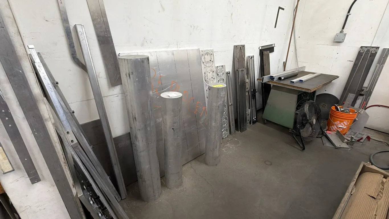 SECTION OF ASSORTED ITEMS INCLUDING; ALUMINUM POLES, SHEETS & OTHER PIECES, PORTABLE WORK TABLE,