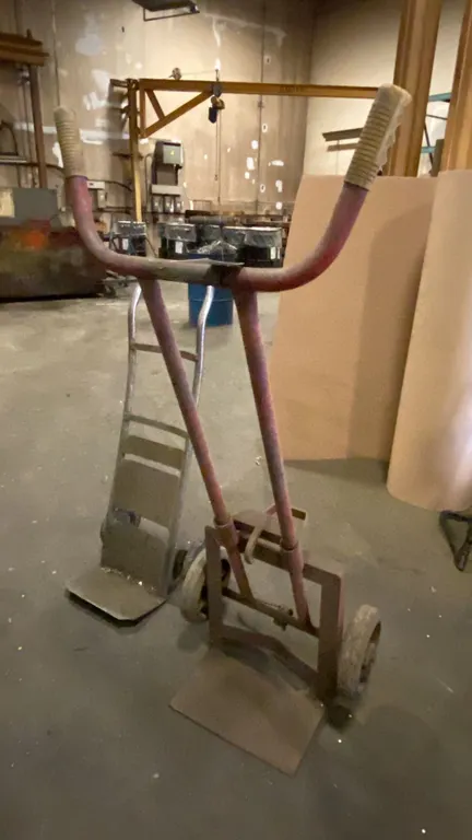 ORANGE BARREL DOLLY AND GREY 2 WHEEL DOLLY