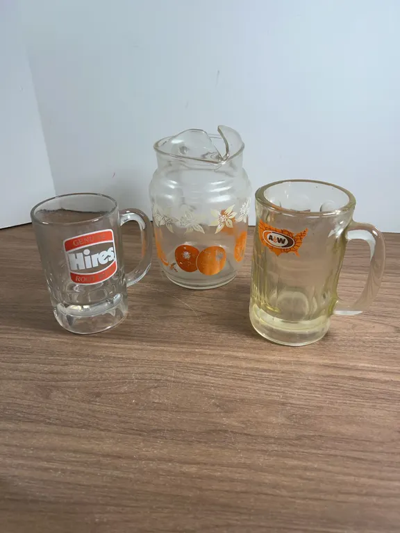 Glass Pitcher with Oranges, Hires and A&W Root Beer Mugs