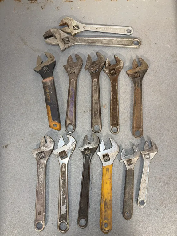Adjustable crescent wrenches