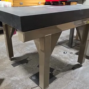 Precision granite surface plate. Dimensions: 36" x 47.5" x 4" (granite slab). Mounted on an industrial steel leveling stand with adjustable feet. Cont