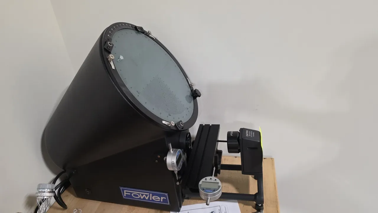 Fowler 53-900-000 optical comparator. Features a 10X projection lens, rotary protractor screen with chart clips, profile and surface illumination, and