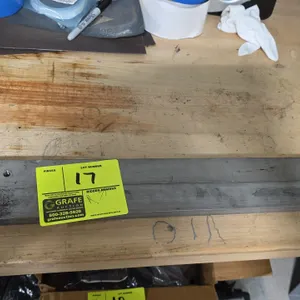 Machined metal bars. Lot of (2). Features slotted mounting holes and threaded holes. Dimensions: 26-1/4" x 1-1/2" x 3/4" each.