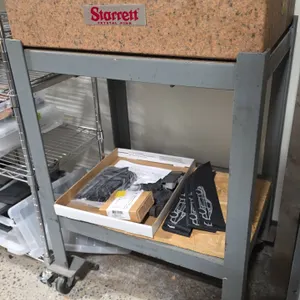 Starrett Crystal Pink granite surface plate. Grade A Inspection. S/N: 993683. Dimensions: 24" x 18" x 6". Mounted on a rolling metal cart with casters
