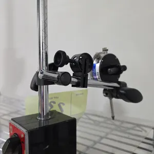 Eclipse magnetic base stand with dial indicator. Features a switchable on/off magnetic base, upright post, cross arm with fine-adjustment clamp, and a