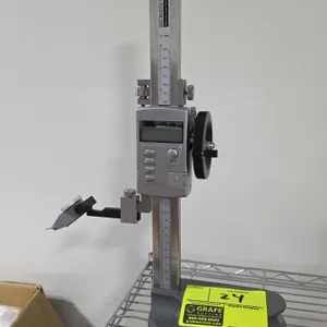 Machine-DRO digital height gauge. Features digital LCD display, metric and inch conversion, handwheel drive, cast base, and mounted dial test indicato
