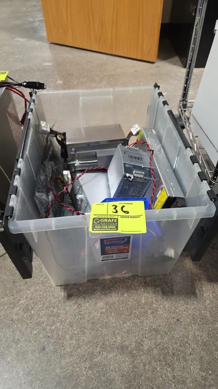Assorted industrial power supplies with a 12-gallon plastic flip-top tote. Includes Sola SDN 10-24-100P (24VDC, 10A), Cosel UAF500S-24 (24V, 22A), Pow