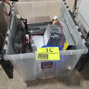 Assorted industrial power supplies with a 12-gallon plastic flip-top tote. Includes Sola SDN 10-24-100P (24VDC, 10A), Cosel UAF500S-24 (24V, 22A), Pow