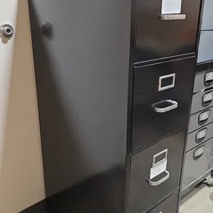 Hon 4-drawer metal vertical file cabinet with contents. Features black finish, 4 drawers with label holders, and pull handles. Includes drawer content