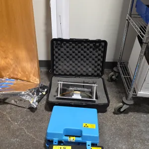 Package lot of metal frame stands with laser diode/sensor array, hard carrying cases, and shop light. Includes Quantel IALDA array marked 40W @ 830 nm