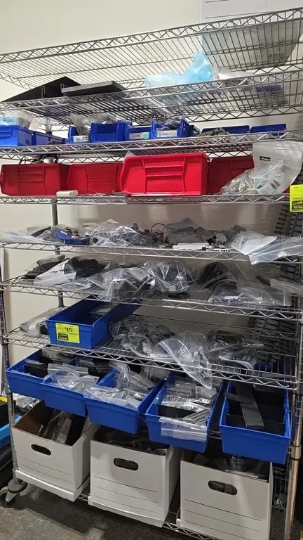 Assorted thermoplastic production parts and electronic components. Includes molded plastic parts, DIN rail terminal blocks, circuit boards, connectors