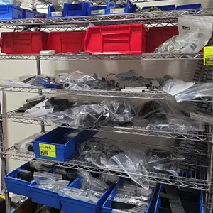 Assorted thermoplastic production parts and electronic components. Includes molded plastic parts, DIN rail terminal blocks, circuit boards, connectors