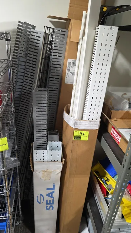 Assorted plastic slotted wiring duct and raceway lot. Includes various lengths of gray and white slotted cable management raceways and channels by bra