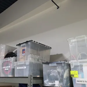 Assorted poly storage totes with contents. Includes (14) plastic hinged-lid storage totes containing assorted pneumatic tubing, cables, thermocouple a