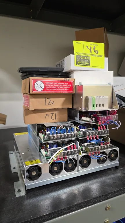 Assorted power supplies, cooling fans, and electrical components. Includes an Allen-Bradley 25-RF027-CL EMC line filter, Cosel UAF500S-24 power suppli