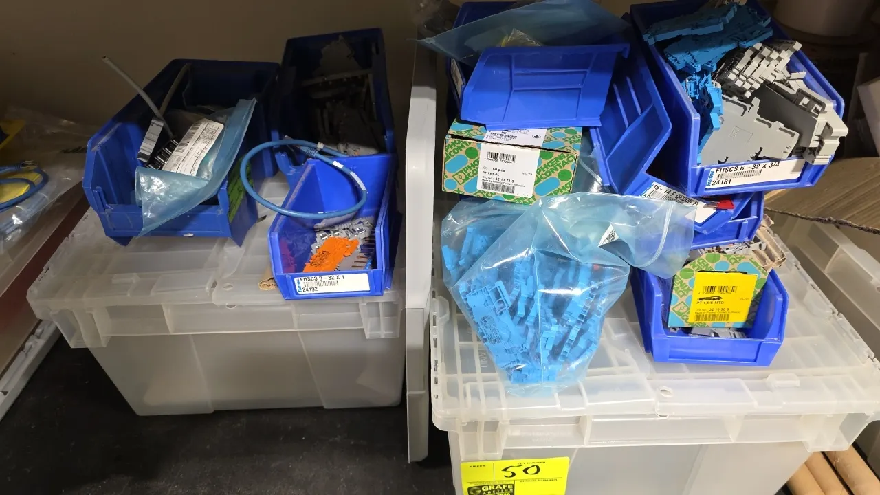 Package lot of storage containers and components. Includes (2) plastic attached-lid totes, blue stacking parts bins, and assorted electrical component