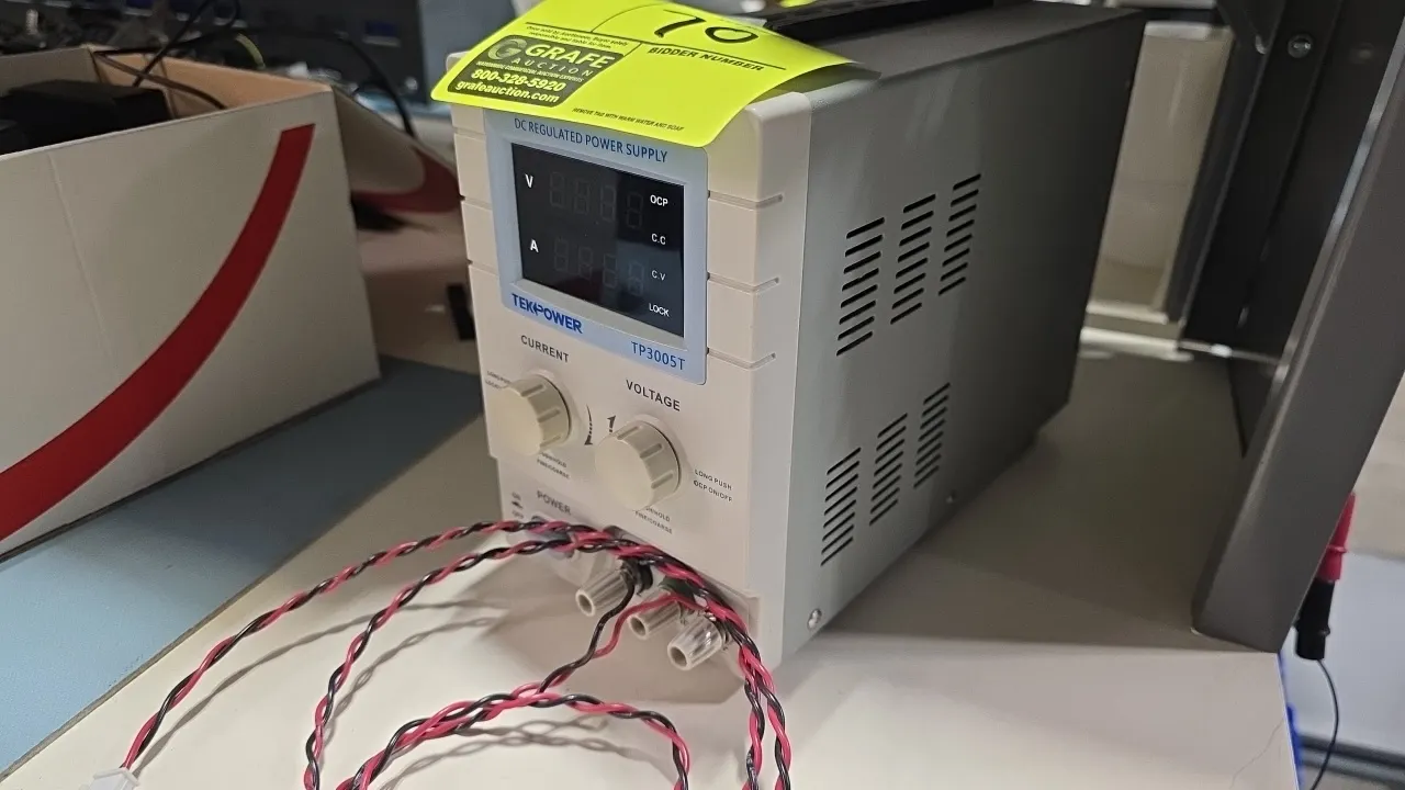Tekpower TP3005T DC regulated power supply. Features digital LED display, adjustable voltage and current control knobs, and front output binding posts