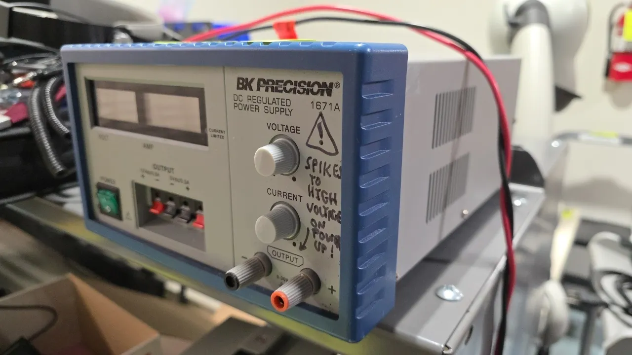 BK Precision 1671A DC regulated power supply. Features digital voltage and current displays, 0-30V/5A variable output, and 5V/12V auxiliary outputs. E
