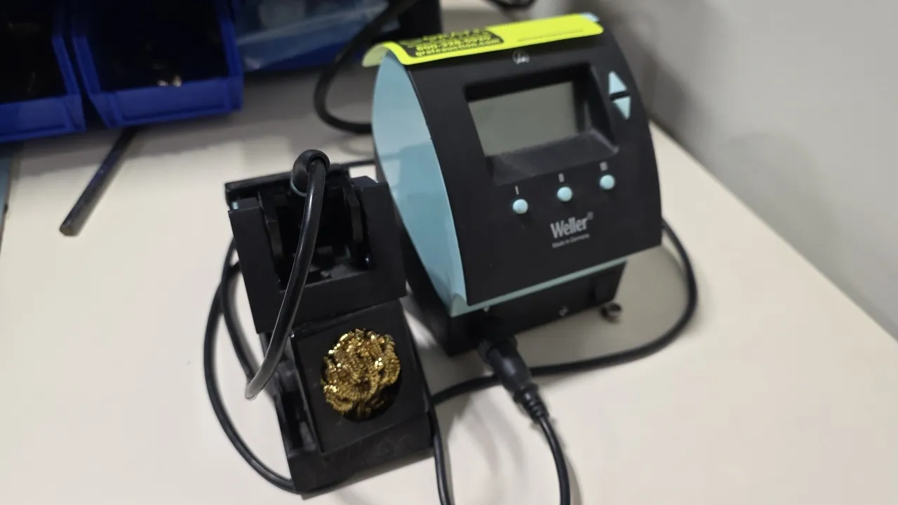 Weller WD 1 digital soldering station. Includes soldering pencil and safety rest stand with brass wire tip cleaner. Features LCD display and push-butt