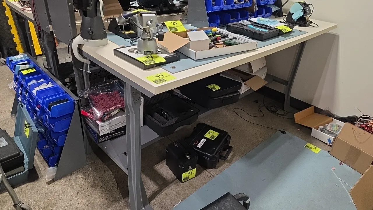 Shop table with overshelf and undershelf. Features laminate work surface and metal frame construction. 72" x 36". Contents not included.