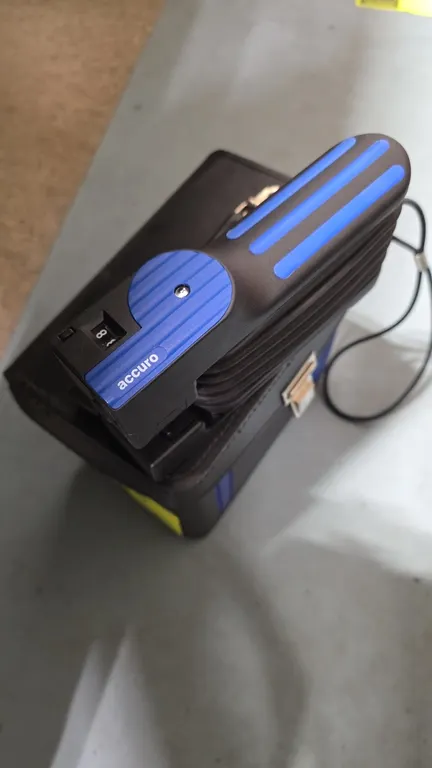 Dräger accuro manual gas detector pump. Features manual bellows operation and integrated stroke counter. Includes hard carry case, tube opener, and as