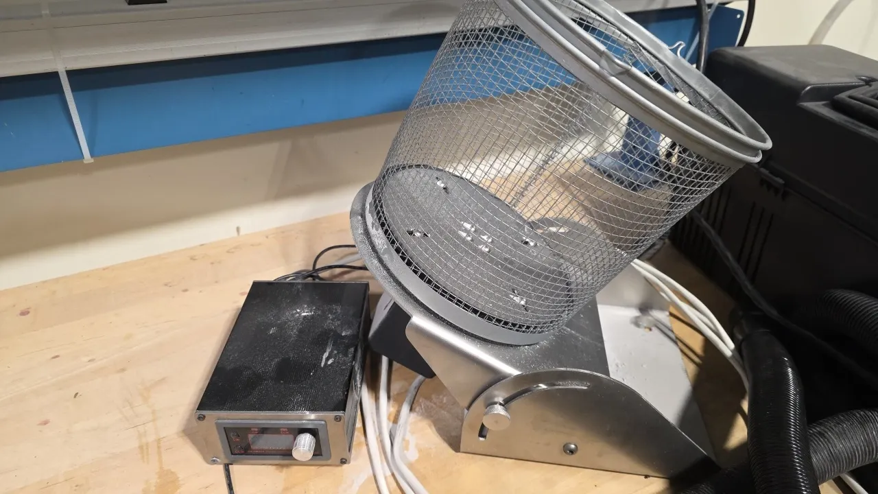 Gimbel Automation rotary tumble basket and portable field vacuum cleaner. Features an adjustable tilt wire mesh tumble basket assembly with digital co