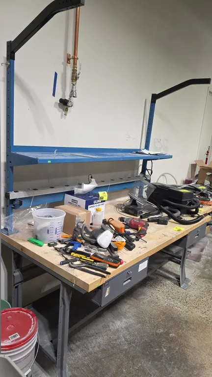 Global workbench. Features wood top, metal frame, upper shelf with overhead support arms, lower shelf, and (2) under-mount storage drawers. 72" x 36".